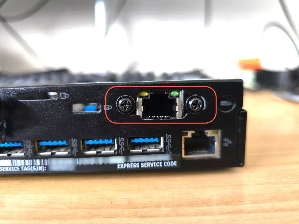 The back of a Dell Optiplex Micro on a desk, highlighting an additional NIC above the original NIC and USB ports