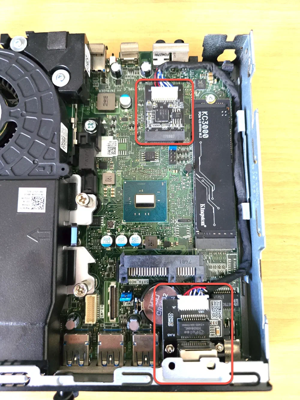 A top down shot of a Dell Optiplex without the cover on, highlighting the new Network Card installed in the Wireless Adapter slot and port.